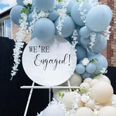 Gostman We're Engaged decal on a balloon arch backdrop for an eye-catching party photo.