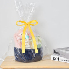 ABenkle round basket on bedside table adds decorative storage.