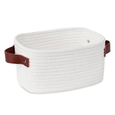 ABenkle small storage basket with white handle keeps compact items neatly organized.