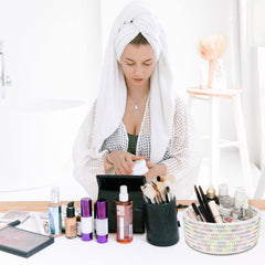 ABenkle small woven basket on bathroom vanity for makeup and brushes.
