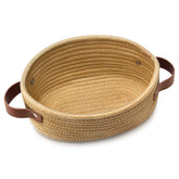 ABenkle small woven basket top view for compact nursery storage.
