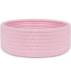 ABenkle small woven pink basket on a shelf for tidy desk storage