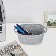 ABenkle white decorative basket with handles blends with decor while keeping essentials accessible.