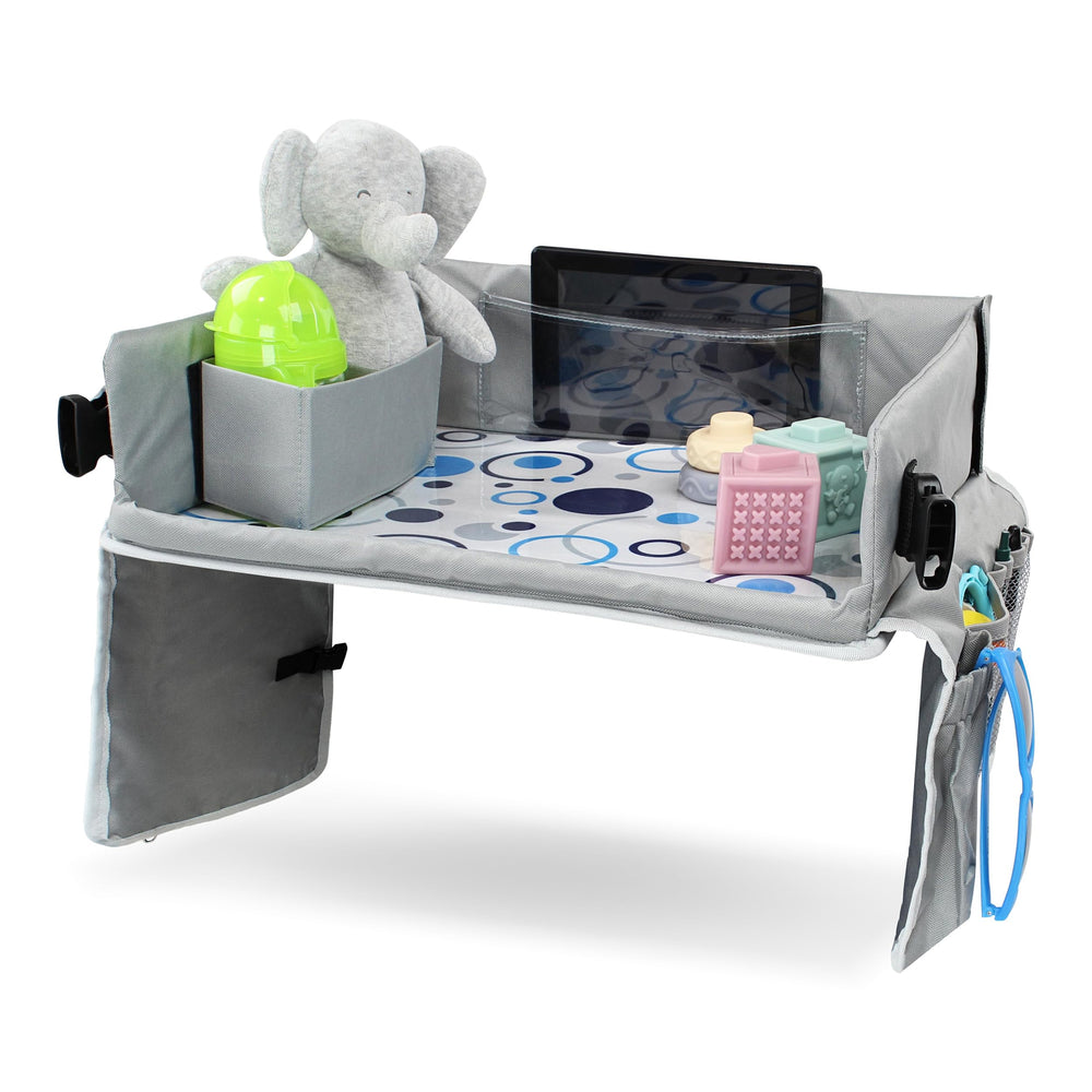 Acorn Baby foldable backseat tray table close-up shows organized storage for toys and snacks.