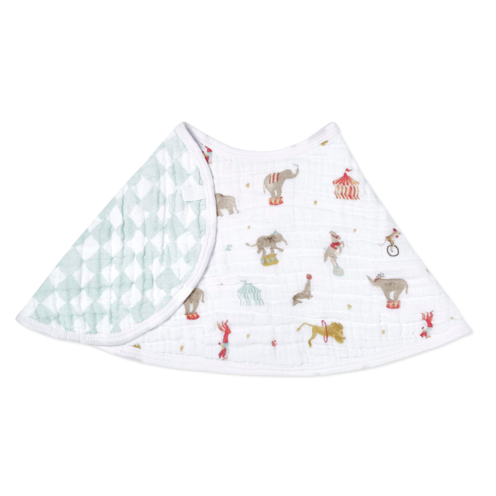 aden + anais Essentials Burpy Bib drapes over shoulders protecting baby outfits from spills