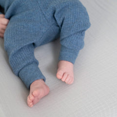 aden + anais essentials changing pad cover shows strap-slot openings for safety restraints