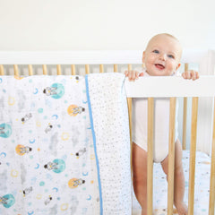 aden + anaïs Essentials Dream Blanket under a baby resting with space explorers print for soft warmth.