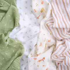 aden + anais essentials muslin swaddle Sage Woodland in action for swaddling, burping, or nursing cover.