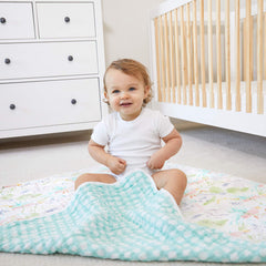 aden-anais Tropicalia Dream Blanket spread during playtime for versatile use.
