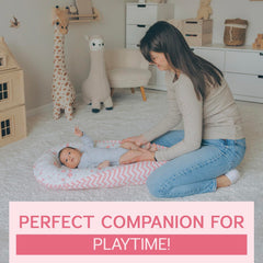 Aila+Aiden baby lounger pink in supervised use during diaper changes and bonding.