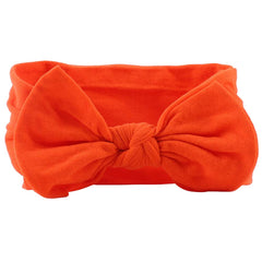 AKOAK orange headband close-up, stretchy nylon for gentle daily styling.