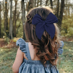 AMYDECOR Fable bow with sturdy alligator clip ready to secure hair all day.