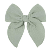 AMYDECOR light-green fable bow enhances outfits with soft linen texture and all-day comfort.