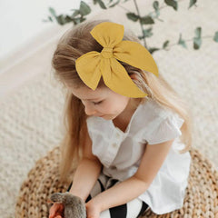 AMYDECOR Yellow Fable Bow on hair clip demonstrates secure hold for active play.