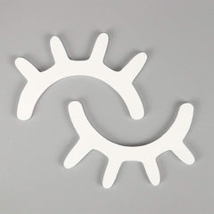 Amyzor sleepy eyes wall decor in white with wooden lashes for nursery walls.