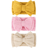 AQOKKA baby bows headbands bow design close-up highlights adorable outfit enhancement.
