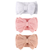 AQOKKA baby bows headbands close-up showing a vibrant bow and soft nylon blend for photo-ready outfits.