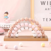 Arrowbash pink rainbow wooden decor; compact shelf display for playful learning.