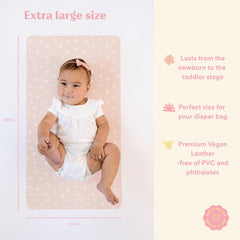 Ava + Oliver pink daisies changing mat folded in a diaper bag for travel.