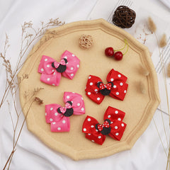Ayesha mouse ears bow clip close-up shows ribbon texture and glitter.