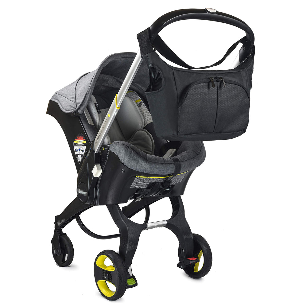 Baby & Beyond Essential Bag attached to Doona hooks for secure stroller compatibility
