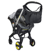 Baby & Beyond Essential Bag attached to Doona hooks for secure stroller compatibility