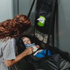 Baby Change-N-Go hangs over a stall door for private changing in public restrooms