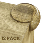 Baby Proof Me table corner protectors 12-pack on wooden edge for safe play.