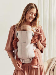 BabyBjörn Baby Carrier Mini satin-woven close-up emphasizes smooth fabric against baby’s skin.