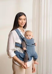 BabyBjörn Harmony blue facing-out shows exploration-ready carrying.