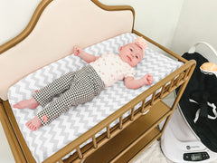 BaeBae Goods changing pad cover with elastic edge fit demonstrating secure mat hold