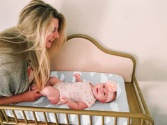 BaeBae Goods elasticated edge changing mat cover provides a secure fit during diaper changes.