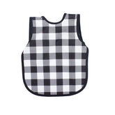 Shows BapronBaby white buffalo plaid bapron front view for mess-free mealtimes.