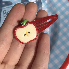 BBTDIN Apple bow clip worn by infant girl, charming school accessory.