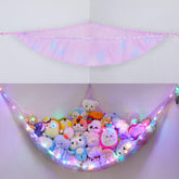 BeBeJoJo stuffed animals storage hammock in light pink displayed in a corner for space saving