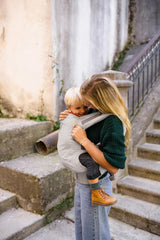 Beco carrier with detachable hood in ecru offers shade or nursing cover.
