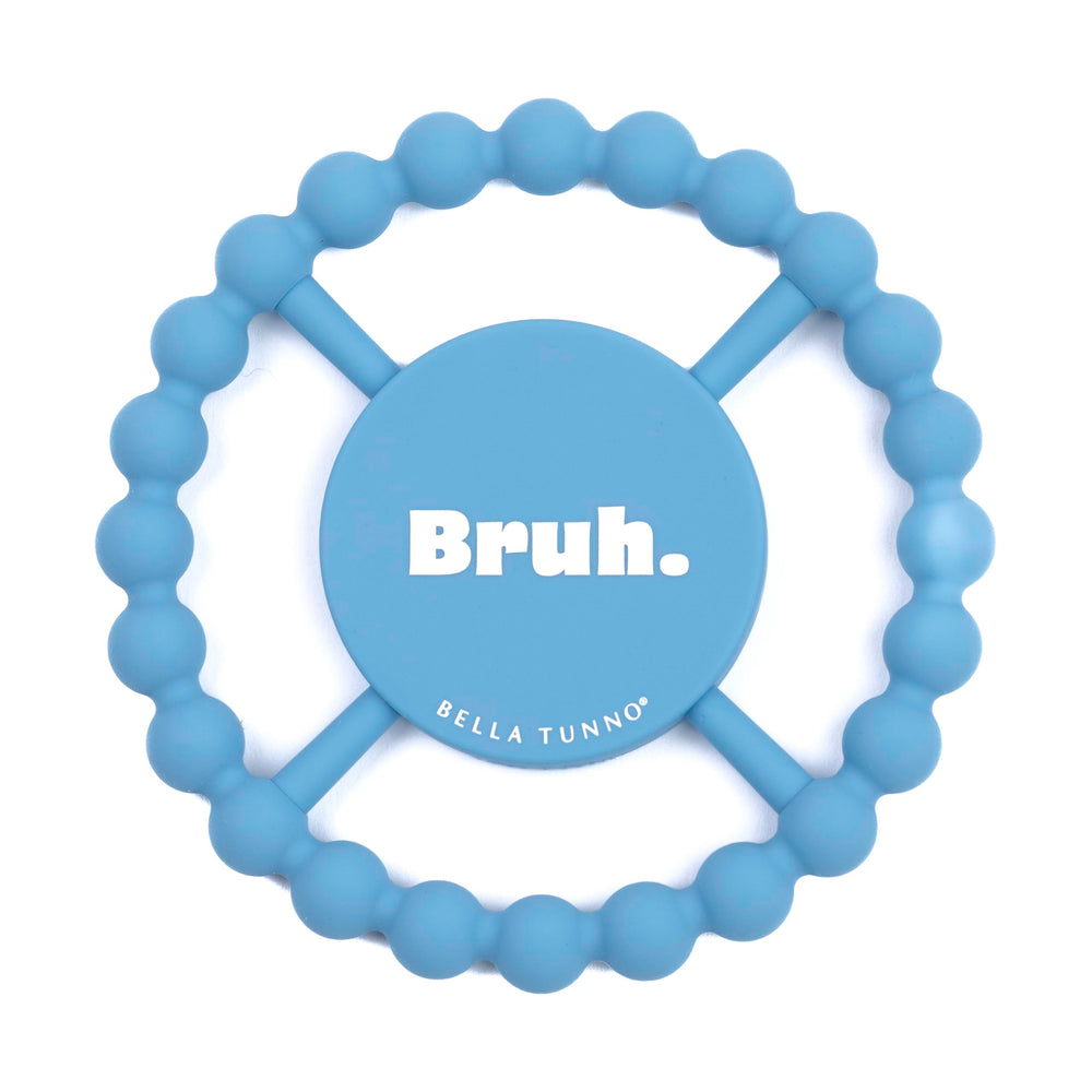 Bella Tunno Bruh teether held by baby shows easy grip for tiny hands and natural soothing.