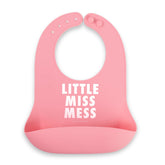 Bella Tunno Little Miss Mess bib on table catching crumbs for mess-free meals.