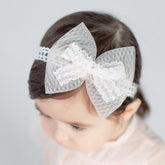 Bethynas baby bow-knot headband closeup shows delicate lace for gentle infant comfort