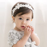 Bethynas baby bow headband, soft lace floral front, comfortable newborn accessory.