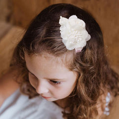 BFNAAgirl flower hair clip paired with party dress for photos.