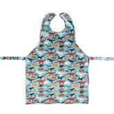 BIB-ON XL dinosaur bib worn during mealtimes for full neck-to-lap coverage.
