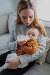 BIBS glass bottle close-up highlighting blush-cap design and secure grip.