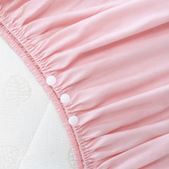 Biloban crib skirt pink pleated side view demonstrates easy attachment and secure fit