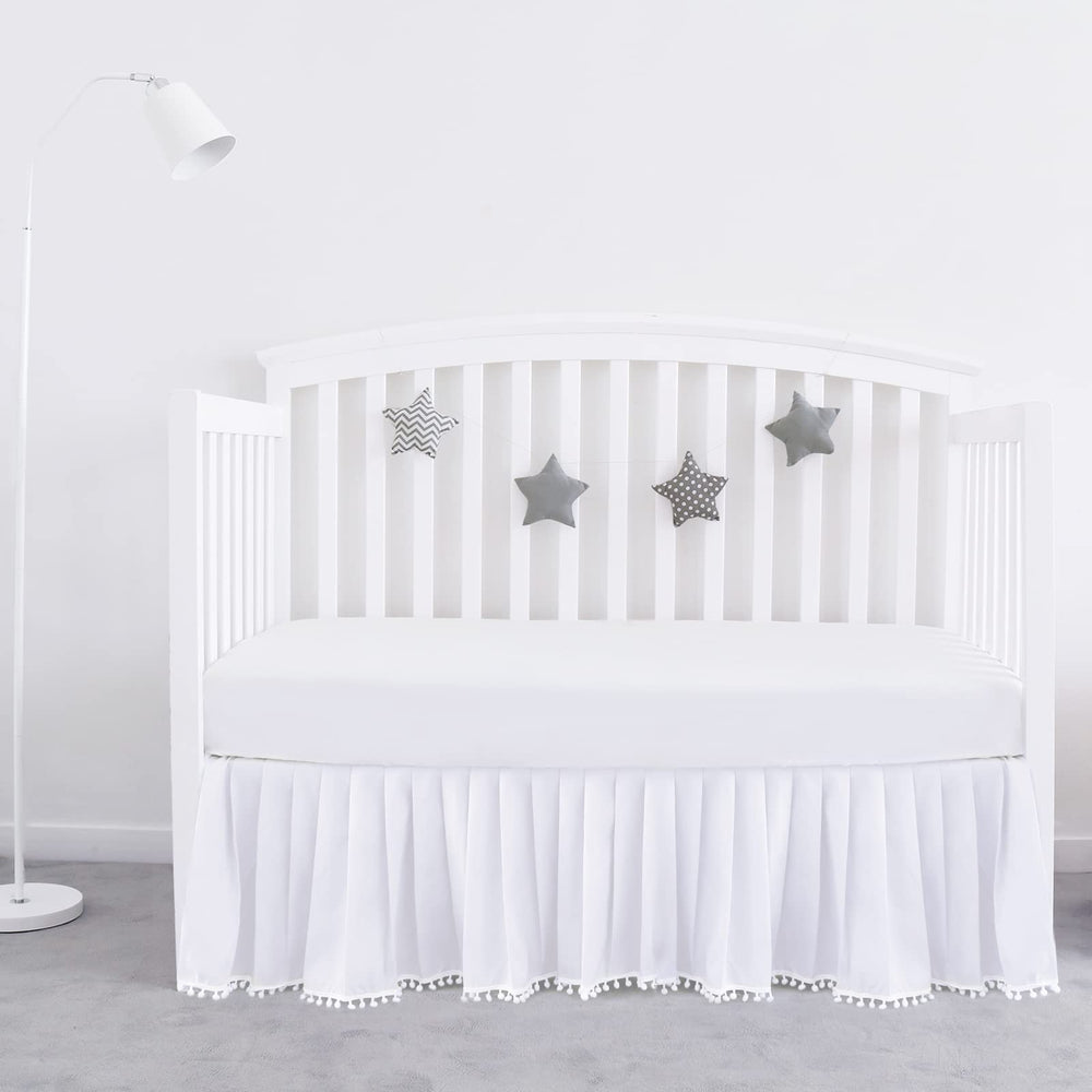 Biloban crib skirt white pleated pompoms adds stylish dimension to nursery.