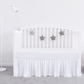 Biloban crib skirt white pleated pompoms adds stylish dimension to nursery.