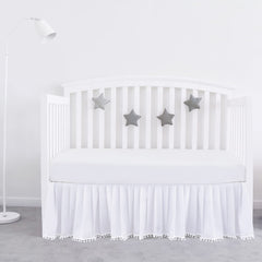 Biloban crib skirt white pleated pompoms adds stylish dimension to nursery.