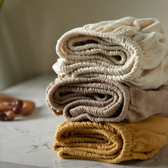 Bioweaves crib sheet with elastic edges demonstrates a secure 8-pocket fit for standard cribs.