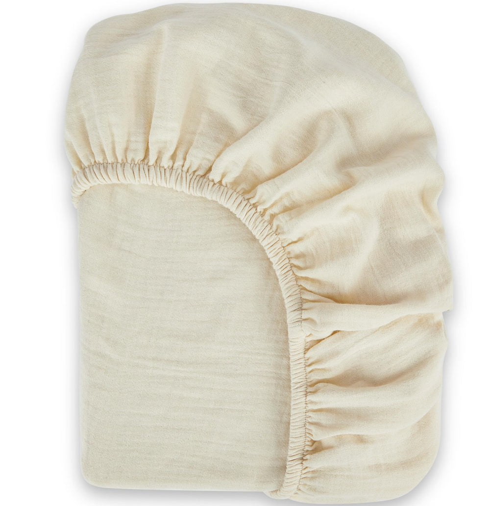 Bioweaves organic muslin crib sheet close-up shows soft breathable texture for delicate baby skin.