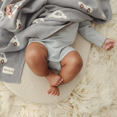 Bleu La La baby blanket folded in a nursery for cozy decor.